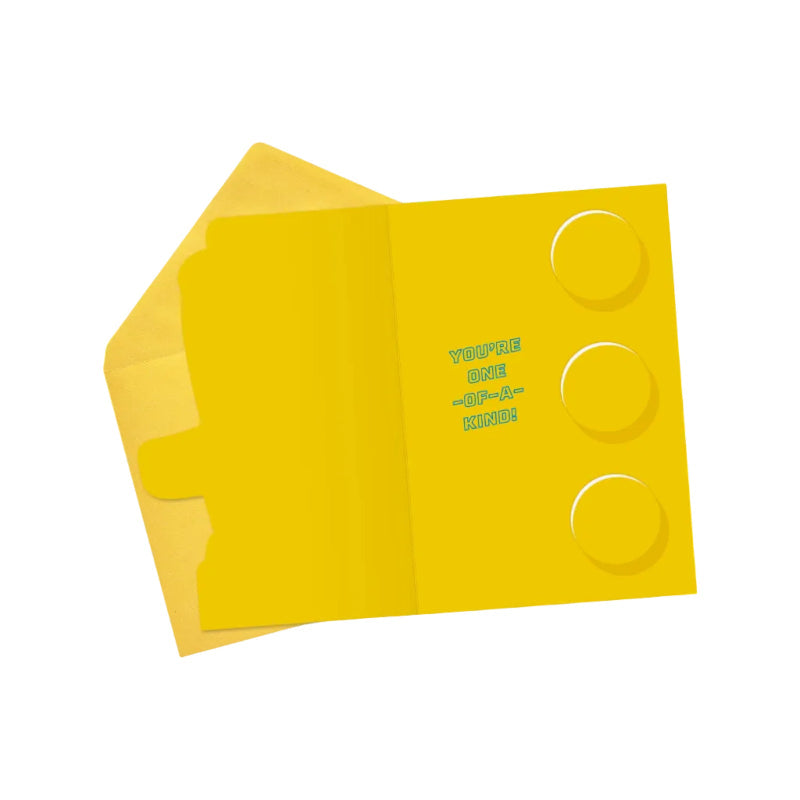 Yellow card with circular cutouts and text on a white background