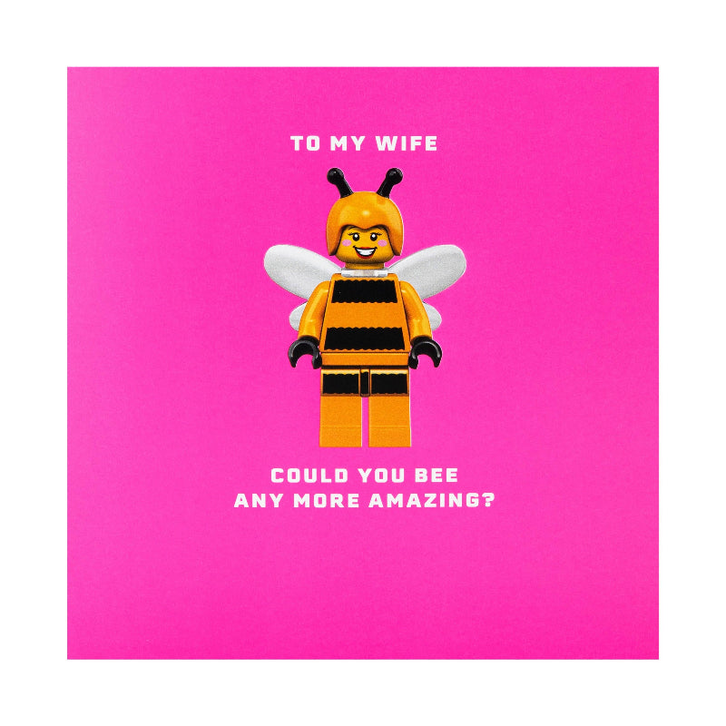 Toy figure of a bee with text on a pink background