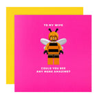 Greeting card with a bee-themed character and text on a pink background