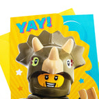 LEGO character with dinosaur helmet on a colorful background with 'YAY!' text